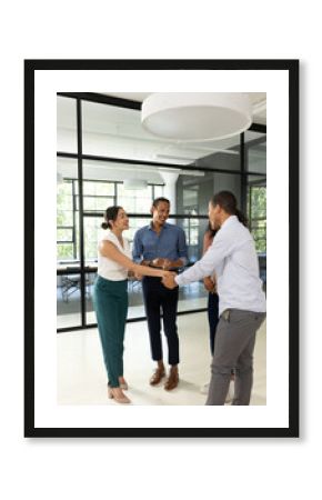 Business professionals in office shaking hands and smiling during meeting