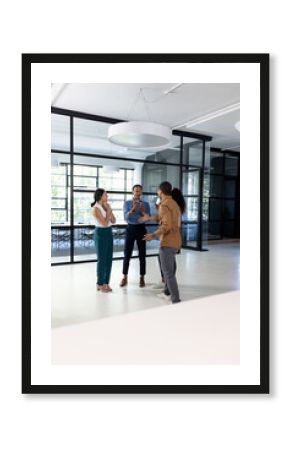 Diverse business team discussing ideas in modern office, smiling and collaborating
