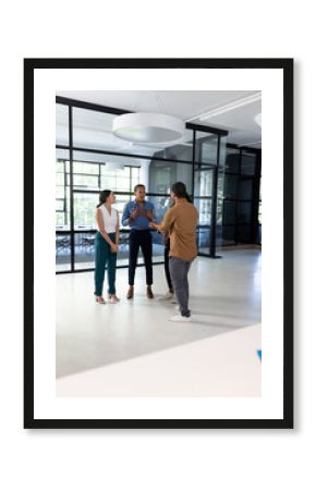 Business team discussing project in modern office, standing and engaging actively