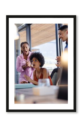In office, African American woman surprised by colleagues, celebrating exciting news