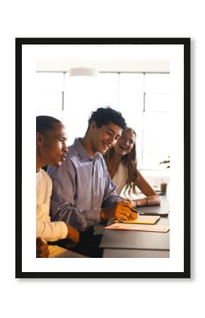 Colleagues collaborating at office, smiling and discussing ideas during meeting