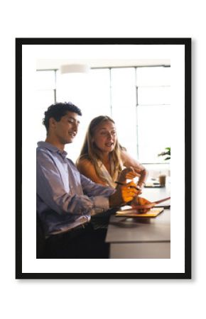 Discussing project details, colleagues collaborating with enthusiasm and focus at office