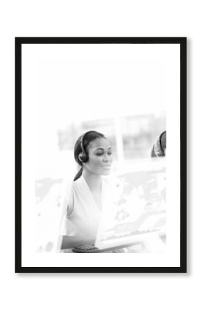 Black and white diverse business people using phone headsets in office