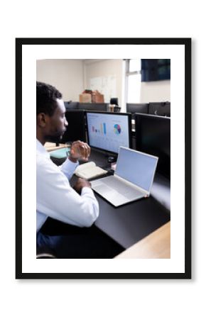 Business professional analyzing sales data on computer at office desk, copy space