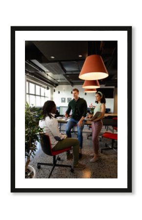 Caucasian manager discussing with colleague in meeting at creative office