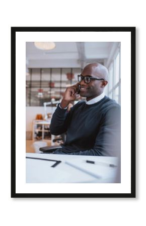 African executive using cell phone while at office