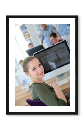 Portrait of student girl sitting in front of desktop