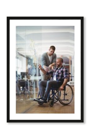 Handicap businessman discussing with colleague at office