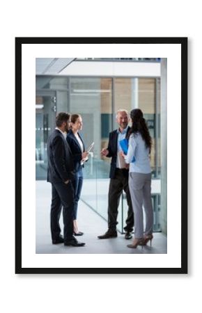 Businesspeople having a discussion in office corridor