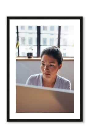 Businesswoman working on computer at her office