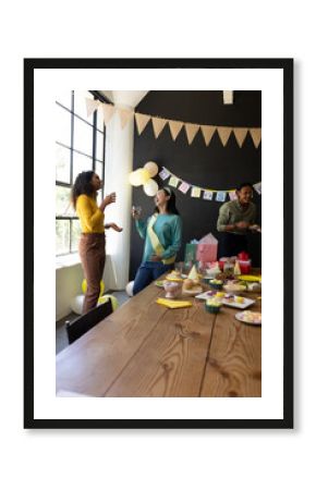 Celebrating at office party, colleagues chatting and having snacks and drinks