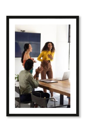 Collaborating in modern office, diverse business team presenting ideas with enthusiasm