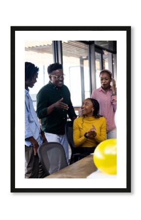 Team collaborating in modern office, smiling and discussing creative ideas together