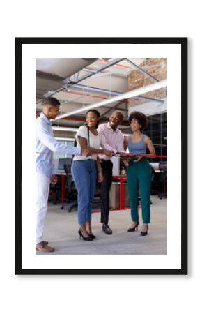 Colleagues cutting ribbon together in modern office, celebrating new project launch