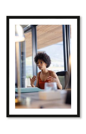 Businesswoman in office discussing ideas passionately during meeting with colleagues