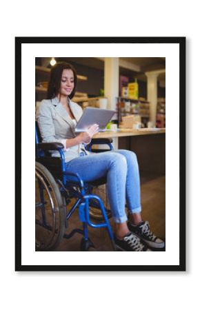 Blue wheelchair resting at wooden table in spacious workspace, featuring silver tablet on seat