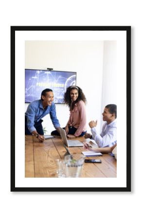 Diverse team discussing project launch in modern office, smiling and collaborating