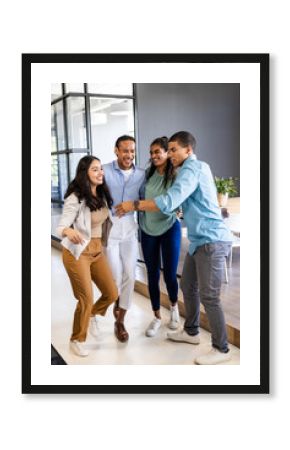 Diverse business team celebrating success together in modern office space