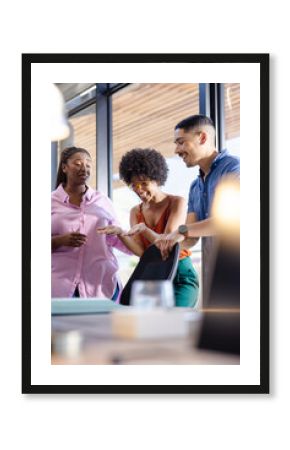 Discussing project enthusiastically, woman with diverse colleagues in modern office