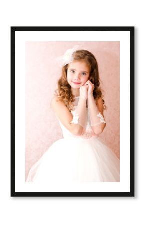 Adorable smiling little girl in white princess dress