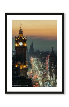 View of Princess Street, Edinburgh, from Calton Hill at dusk, with lights on and beautiful color in the sky. Scotland. Long exposure.