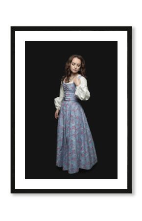 Young beautiful woman in long medieval dress on dark