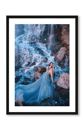 lost princess sitting on wet stones near gorgeous high waterfall, lady in blue dress with delightful long amazing train laid out on water, picked up legs and thought, fairy-tale daughter of aqua