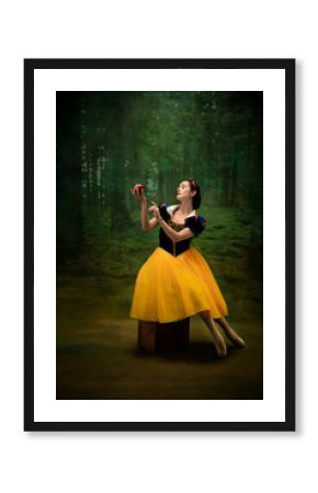 Young ballet dancer as a Snow White with poisoned apple in forest. Flexible caucasian ballerina dances like character of fairytail in bright clothes. Adorable and elegance story in motion and dancing.