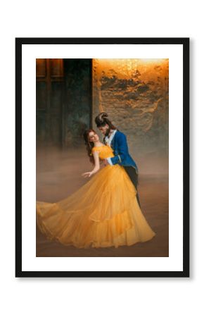 loving couple is dancing at fairy ball. Happy beauty woman fantasy princess in yellow dress and guy is enchanted beast, horns on head Girl whirls in arms of male prince. Man monster carnival costume