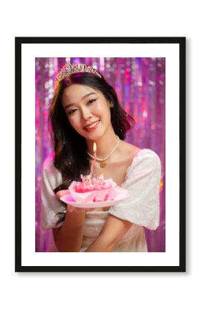 Happy beautiful Asian girl in princess dress showing birthday cake. Birthday princess photography theme is popular in social network.