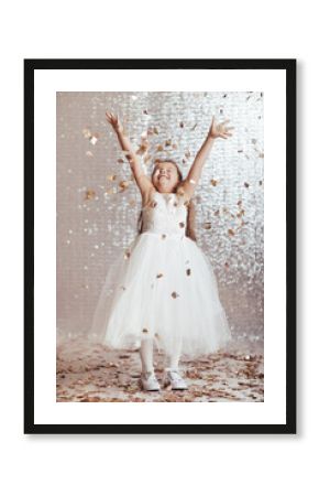 cute little child girl in princess dress on confetti background with silver bokeh. birtday party