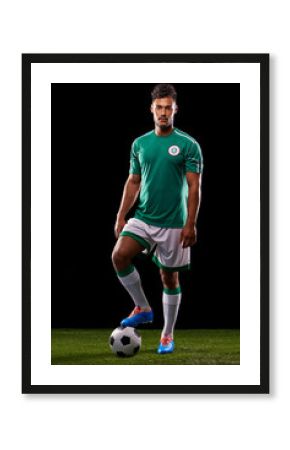 Ready for kick-off. Full length studio shot of a handsome young soccer player isolated on black.