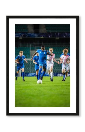 Vertical Shot of Professional Soccer Football Match Championship: Blue Team Attacks, Black Forward Masterfully Dribbles on an International Tournament. Television Channel Broadcast.