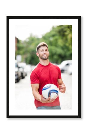 Athlete playing soccer on city streets