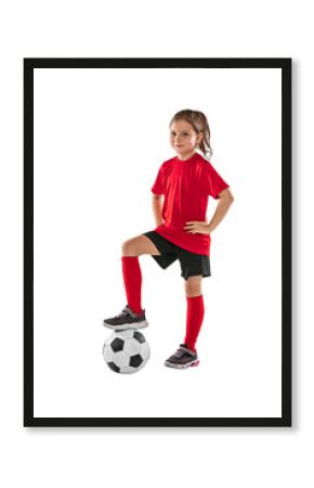 Portrait of girl, child, football player in red uniform training, posing against transparent background. Sportive and active kid. Concept of action, team sport game, energy, vitality.