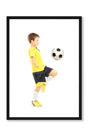 Child in sportswear joggling with a soccer ball