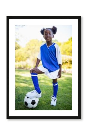 Portrait of girl standing with soccer balloon