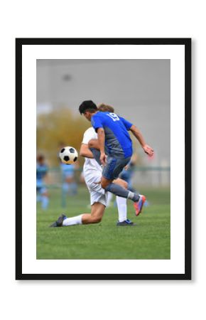 Young teen boys playing soccer