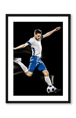 one caucasian soccer player man isolated on black background with light painting speed effect