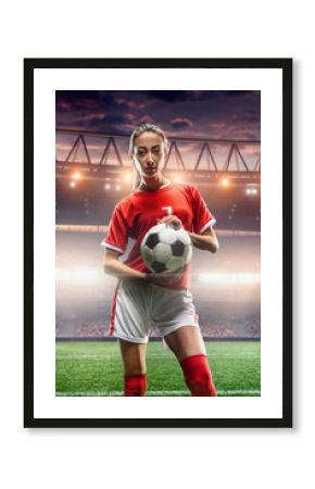 Female Soccer player with ball on a professional soccer stadium