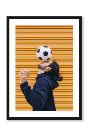 Man playing soccer ball with head