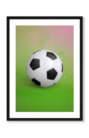 Wet Soccer Ball In Motion Against Green Background
