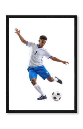 Male athlete wearing blue ready kicking a ball in a powerful strike for a goal