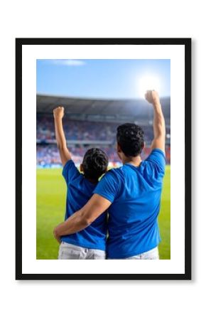 Father and son cheering at a soccer game
