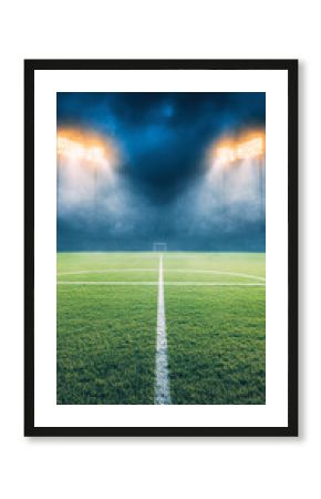 A serene soccer field illuminated by bright floodlights, enveloped in a misty atmosphere.