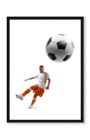Professional soccer. Player kicks the ball on the soccer field. Isolated