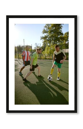 Street football on city soccer field at summer day