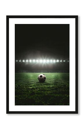 a soccer ball on green field with blur stadium at background