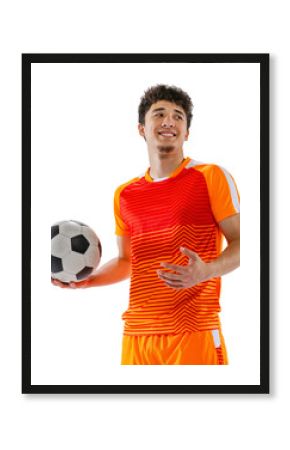 Young man, Asian football, soccer player in orange sportswear posing with ball isolated on white transparent background. Concept of sport, competition, active lifestyle, game