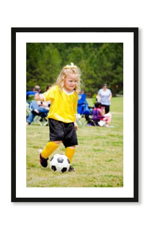 Girl in uniform playing in organized youth league soccer game